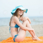34071335-young-lady-sunbathing-on-a-beach-beautiful-woman-posing-at-the-summer-sand-beach-outdoor-s