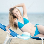 43073377-young-lady-sunbathing-on-a-beach-beautiful-woman-posing-at-the-summer-sand-beach-