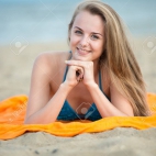 43073451-young-lady-sunbathing-on-a-beach-beautiful-woman-posing-at-the-summer-sand-beach-