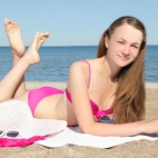 beautiful-girl-pink-bikini-lying-beach-attractive-32664566